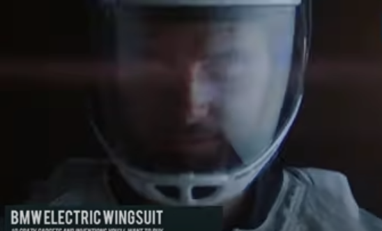 Person wearing futuristic wingsuit soaring through the sky.